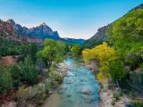 Morning rays illuminate fall colors along the Virgin River and Watchman Peak, Zion National Park, Utah