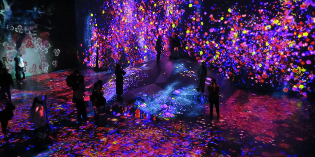 People immersed in the colourful digital art of the teamLab Borderless Museum, Tokyo