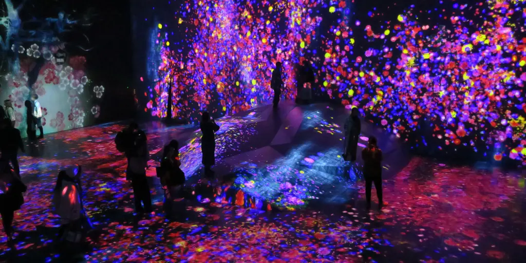 People immersed in the colourful digital art of the teamLab Borderless Museum, Tokyo