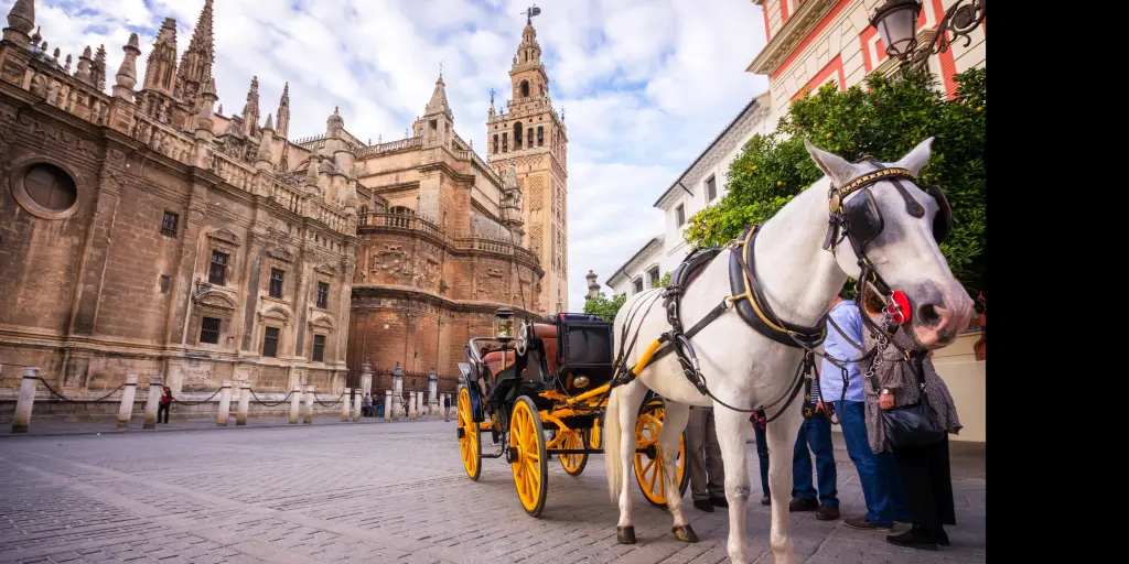 Seville Cathedral with a horse carriage at the front