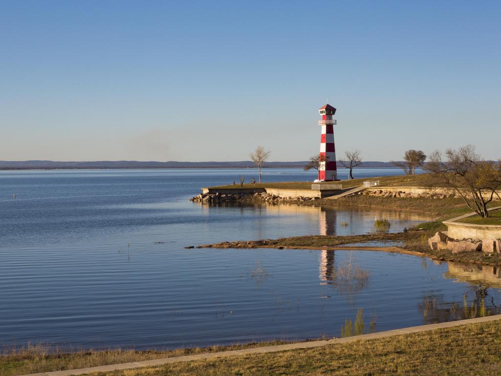 The lighthouse at Lake Buchanan in Texas on a sunny day with blue skies.