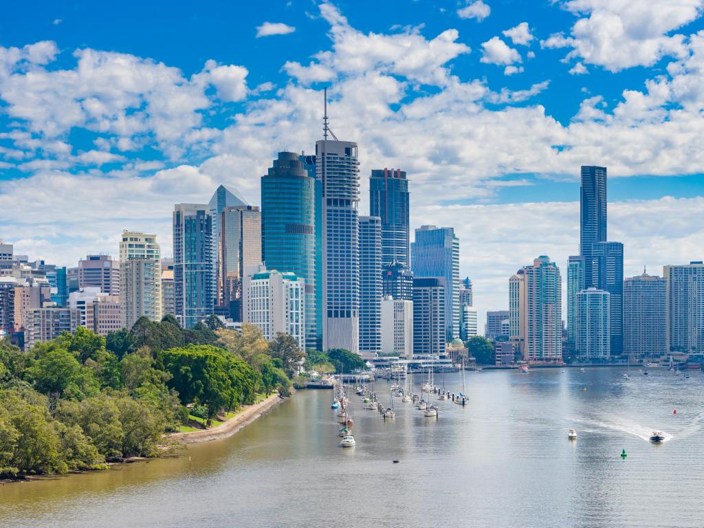 View of Brisbane CBD and Brisbane River in daytime with small boats