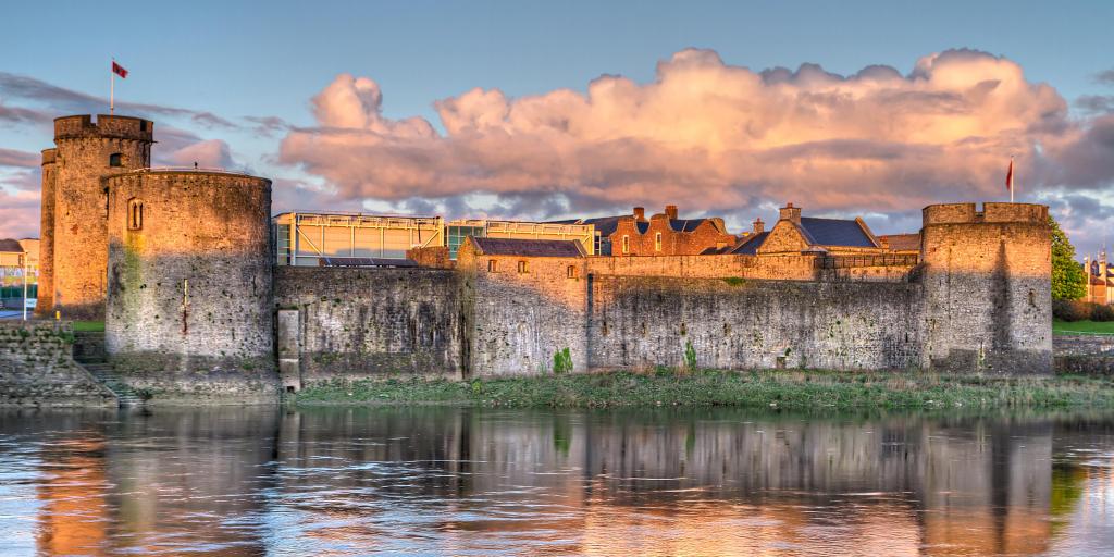 Pink light from the sun lights up King John's Castle in Limerick, Ireland