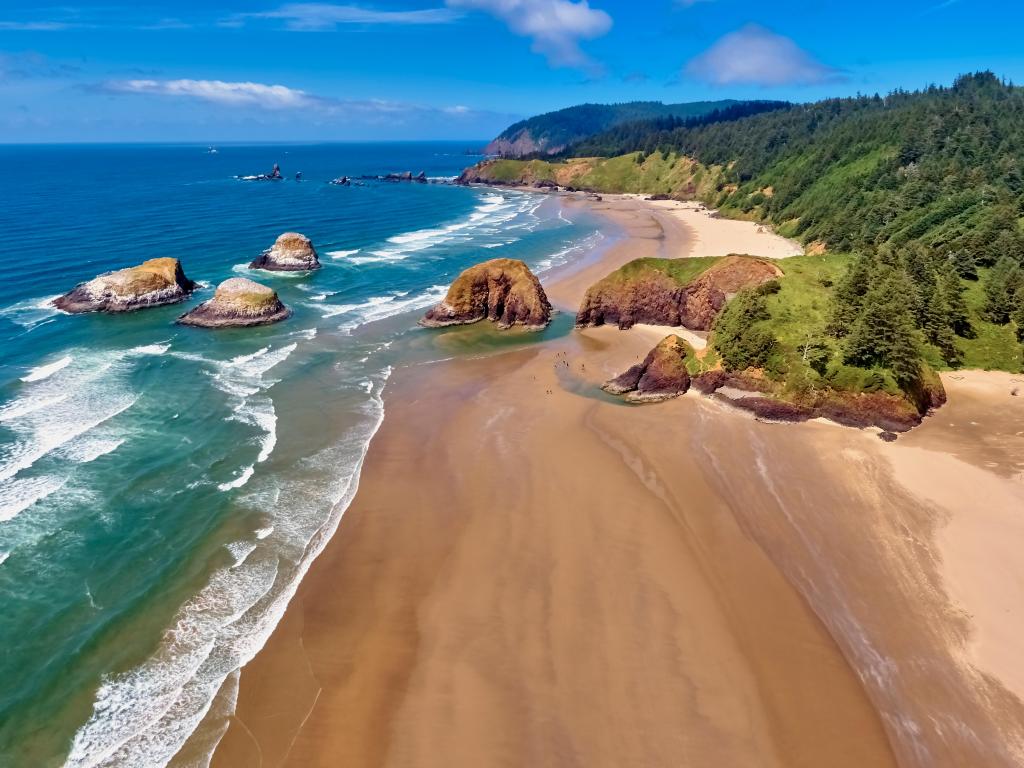 Cannon Beach looking towards Ecola State Park on a sunny blue sky day on the Oregon Coast