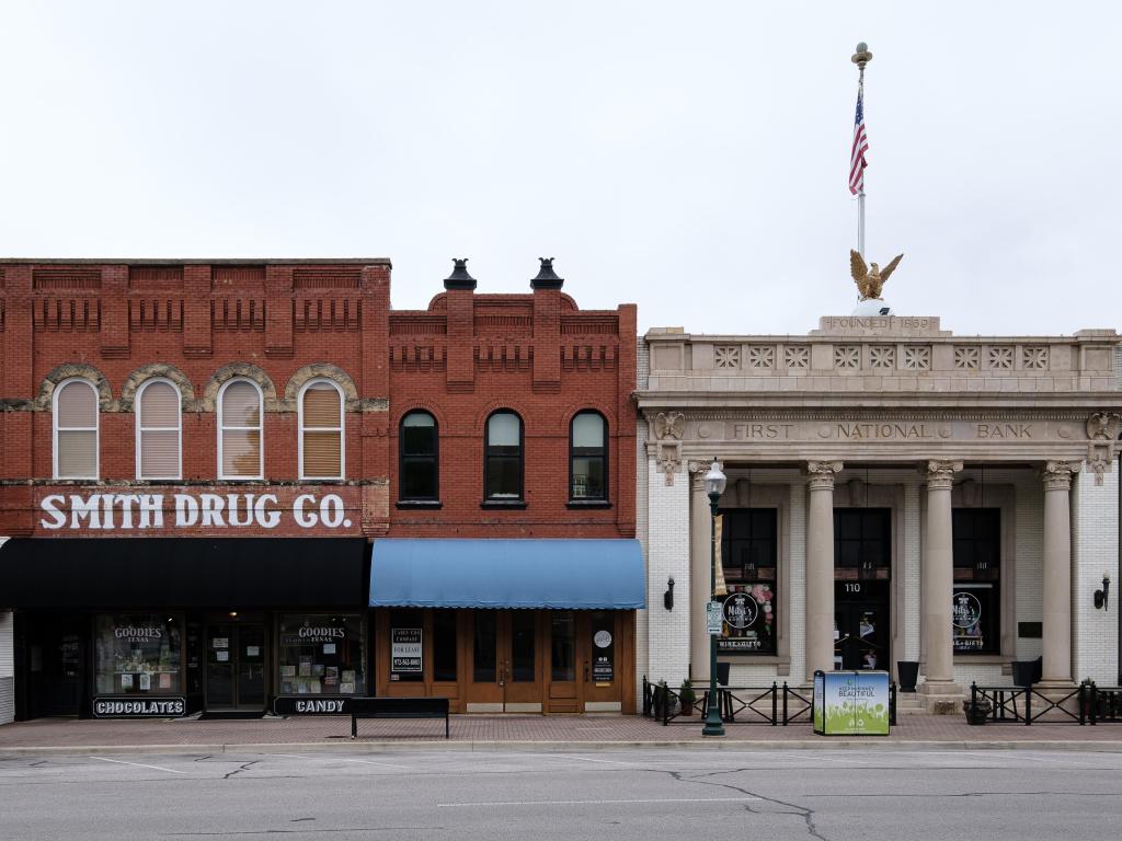 Historic buildings stand in Old Town Historic McKinney in Texas - First National Bank Building and Smith Drug Company