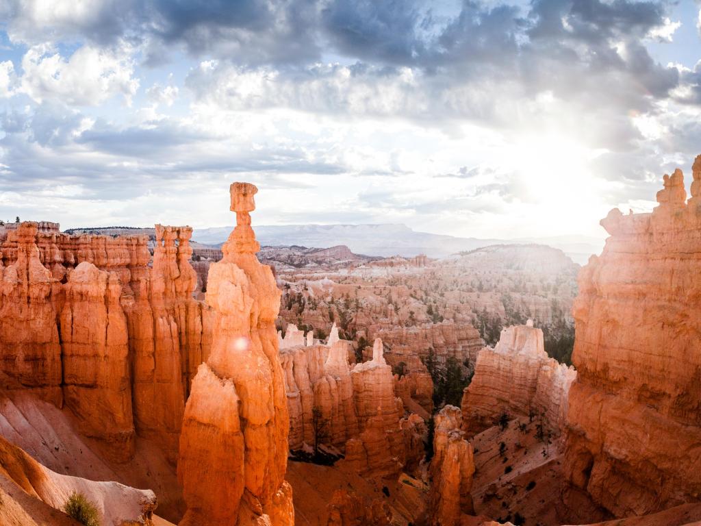 Bryce Canyon National Park, Utah, USA with a panoramic view of amazing hoodoos sandstone formations in scenic Bryce Canyon National Park in beautiful golden morning light at sunrise with dramatic sky and blue sky, Utah, USA