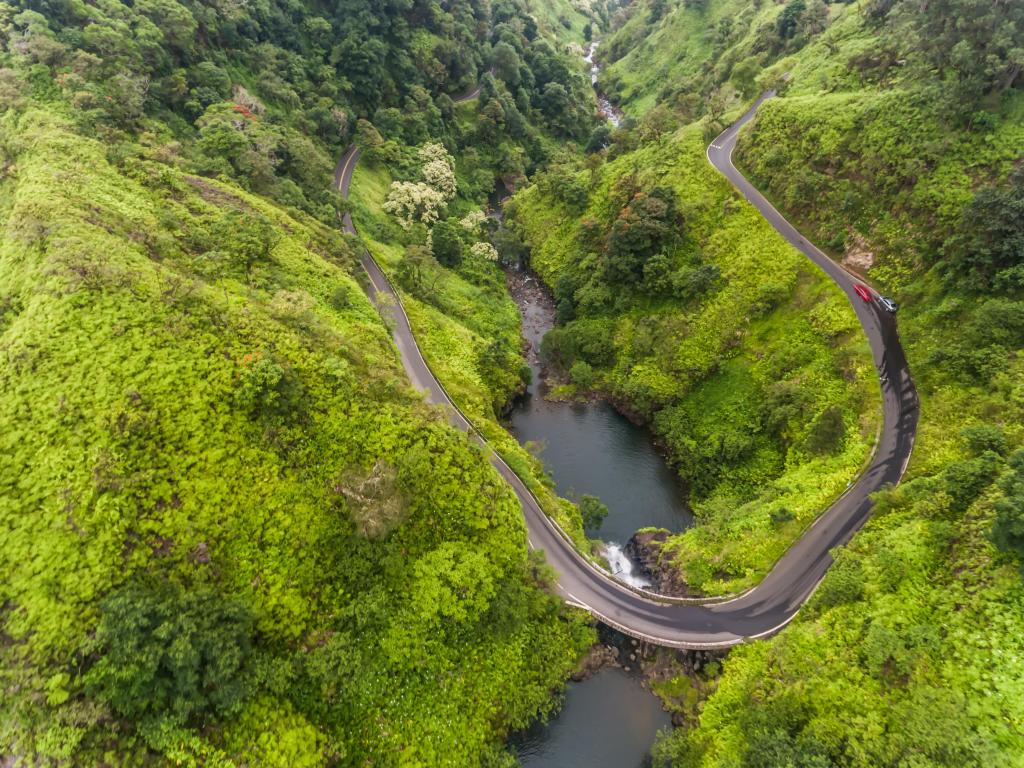 Aerial shot of the famous Road to Hana, winding its way through the mountains and trees on Maui