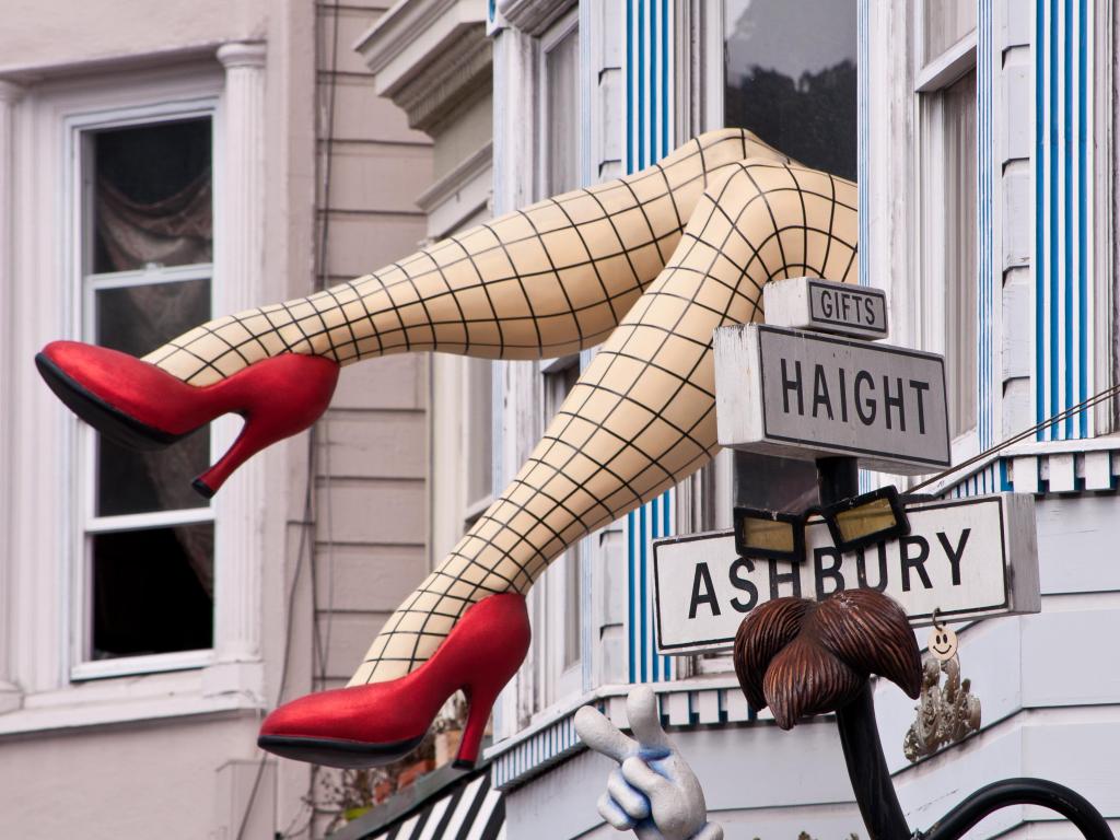 A sculpture of legs out of a window, at the intersection of Haight and Ashbury Streets