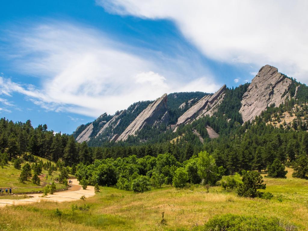Boulder, Colorado, USA with a landscape featuring the Flatirons in summer with mountains in the distance.