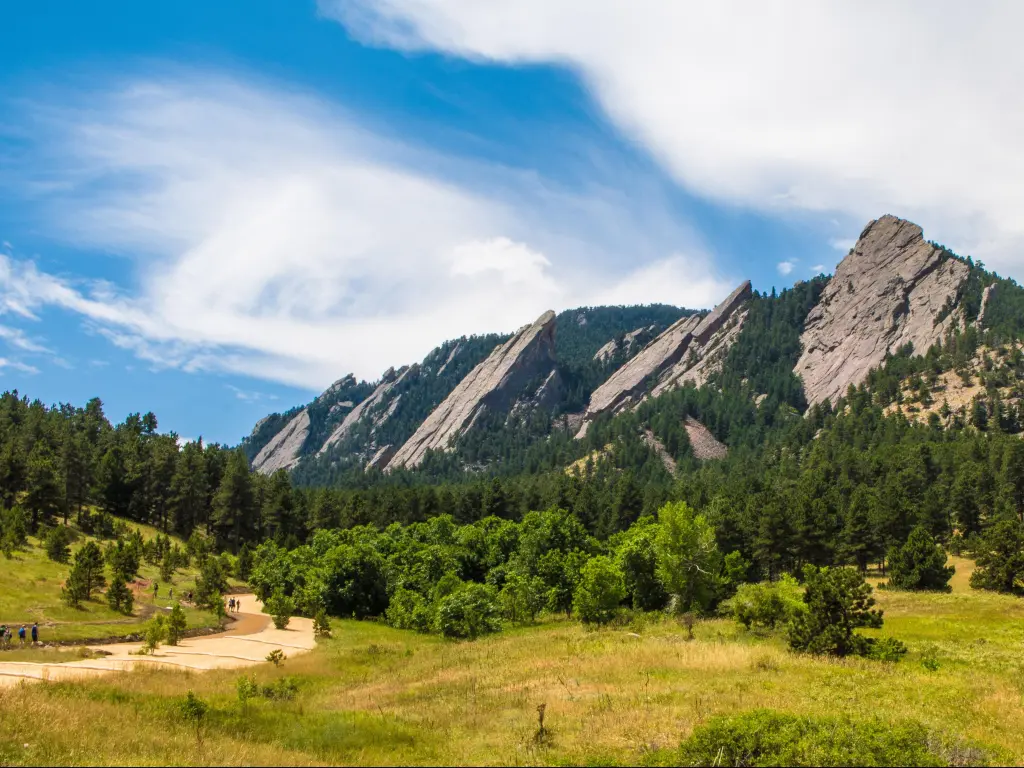 Boulder, Colorado, USA with a landscape featuring the Flatirons in summer with mountains in the distance.