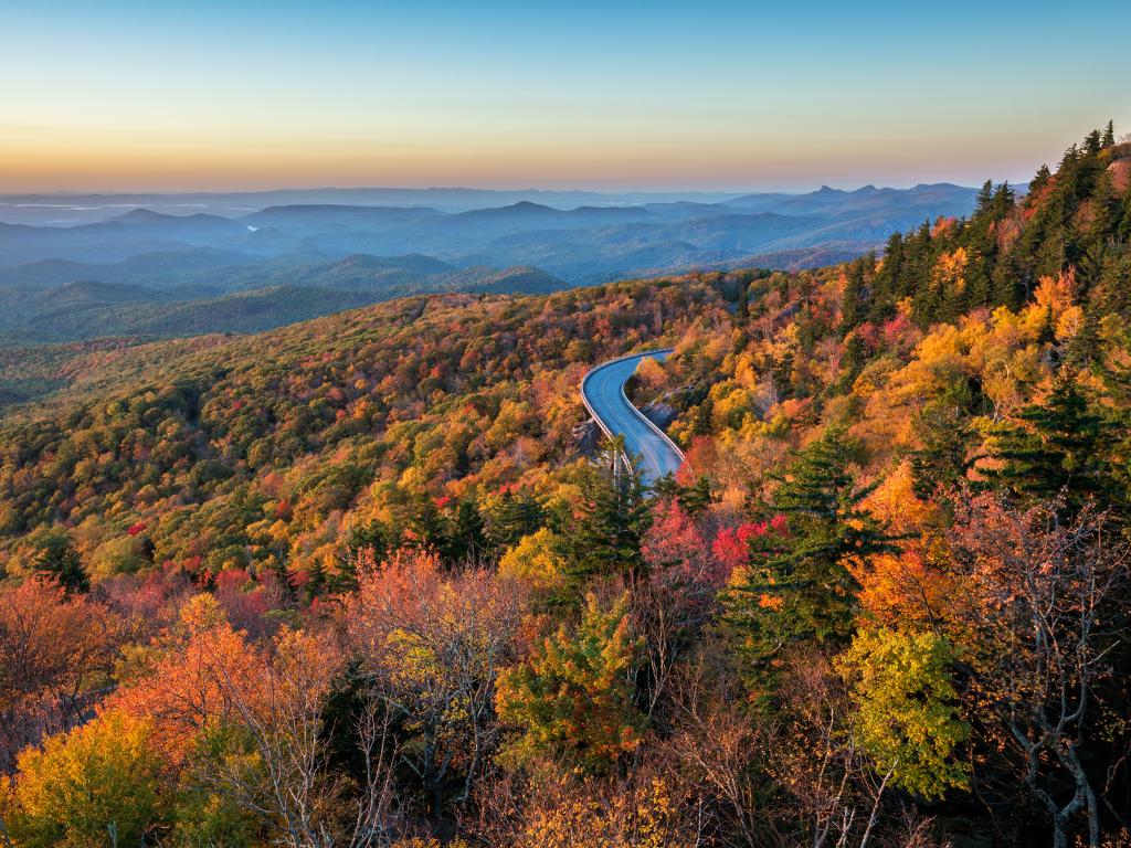 The Blue Ridge Parkway road running through mountains and forests along the Lynn Cove Viaduct in North Carolina.