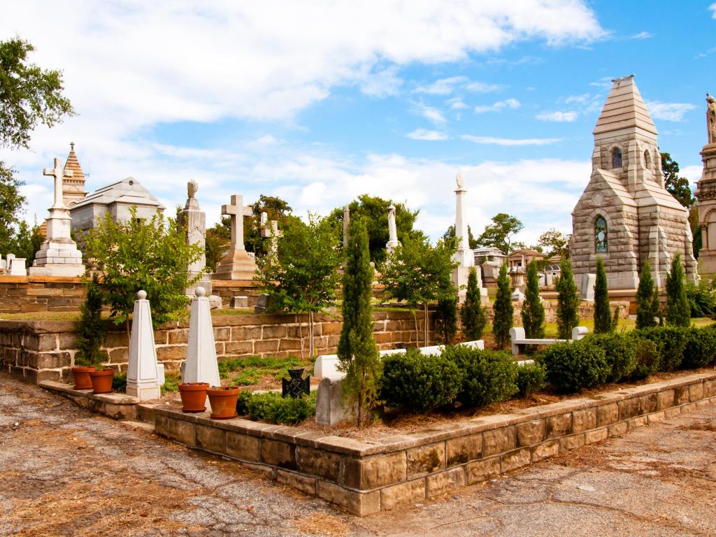 Monuments, tombstones and crypt at the cemetery on a sunny day