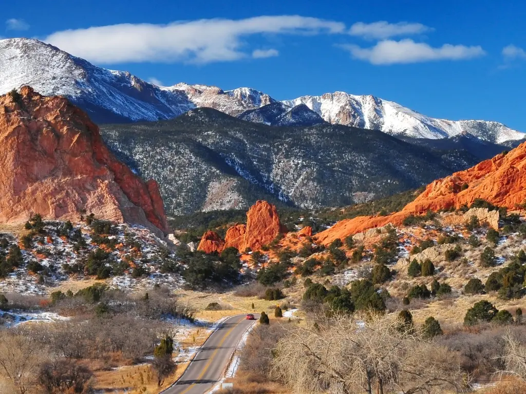Road running between Garden of the Gods and Pikes Peak, Colorado, with snowy mountains in the background