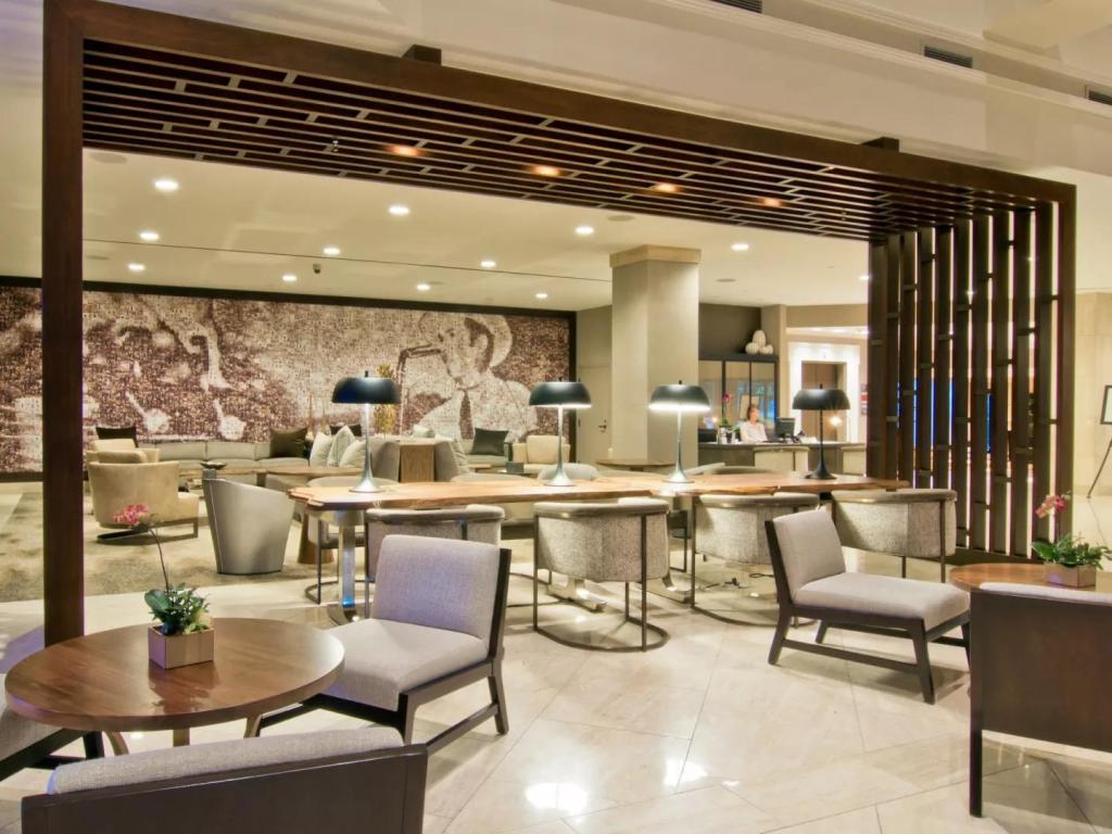 Modern reception and lounge area, neutral decor with artwork, Loews Vanderbilt Hotel