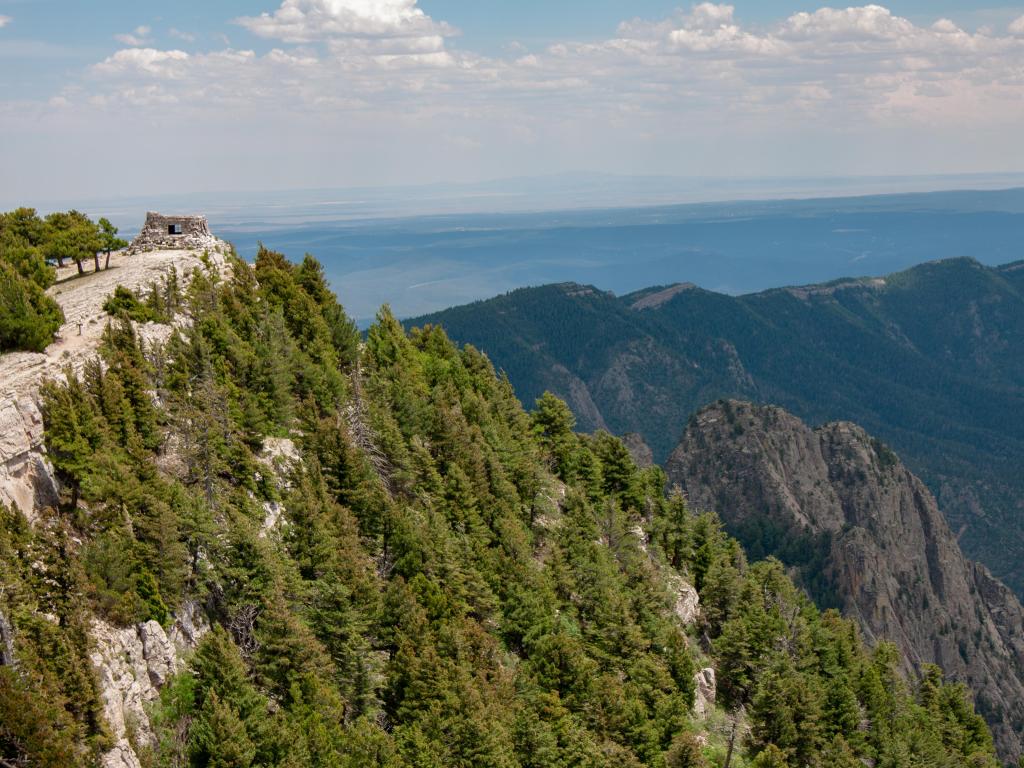 Cibola National Forest, New Mexico, USA with stone ruins of Kiwanis Cabin on a distant peak on the Sandia Crest in the Sandia Mountains outside of Albuquerque.