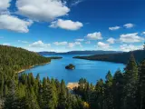 Lake Tahoe on a clear day with mountains in the background and forests in the foreground