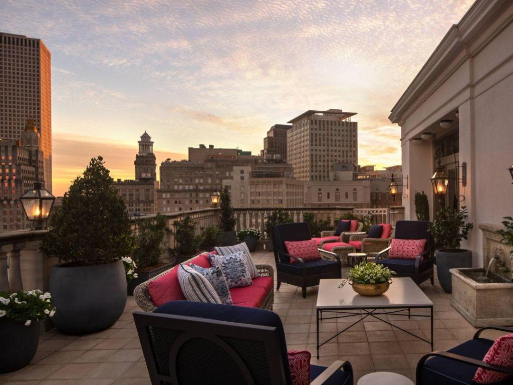 View of the elegant outdoor terrace with seating, and city views, at The Ritz-Carlton New Orleans