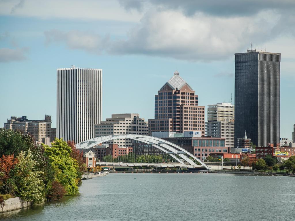 Rochester, New York, USA with the water in the foreground and the city skyline in the background, taken on a cloud but sunny day.