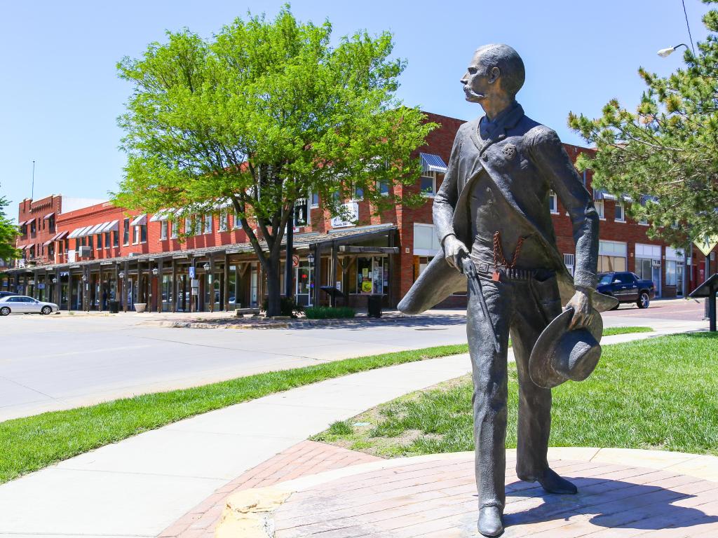 Dodge City, Kansas, USA taken at the bronze sculpture of Wyatt Earp as part of the Trail of Fame in the historic district of the city on a sunny day.