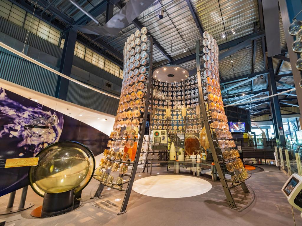 Interior view of the Corning Museum of Glass, a metal structure with glass components is in focus 