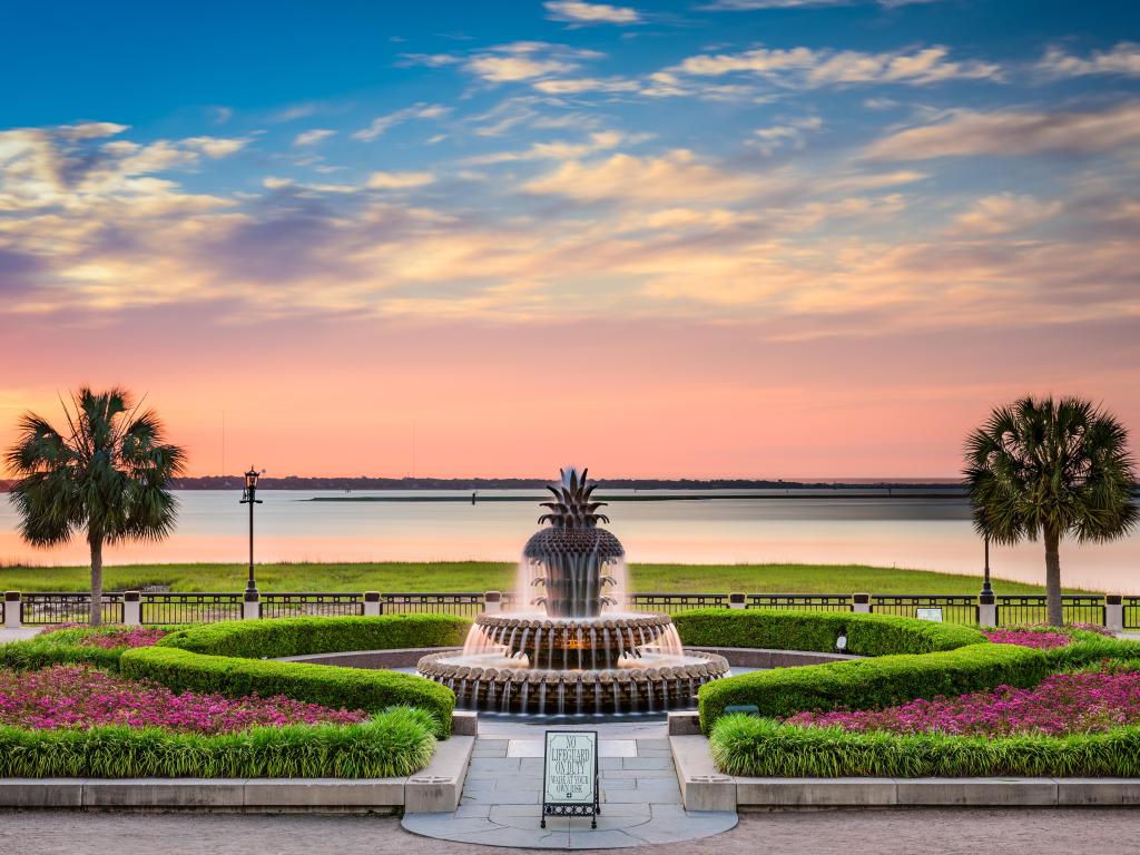 Sunset view of lush and manicured gardens and iconic pineapple fountain Waterfront Park