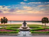 Sunset view of lush and manicured gardens and iconic pineapple fountain Waterfront Park