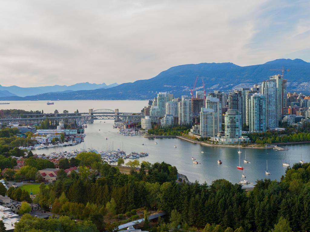 Vancouver, Canada with a panorama view taken from False Creek and the stunning mountains in the distance.