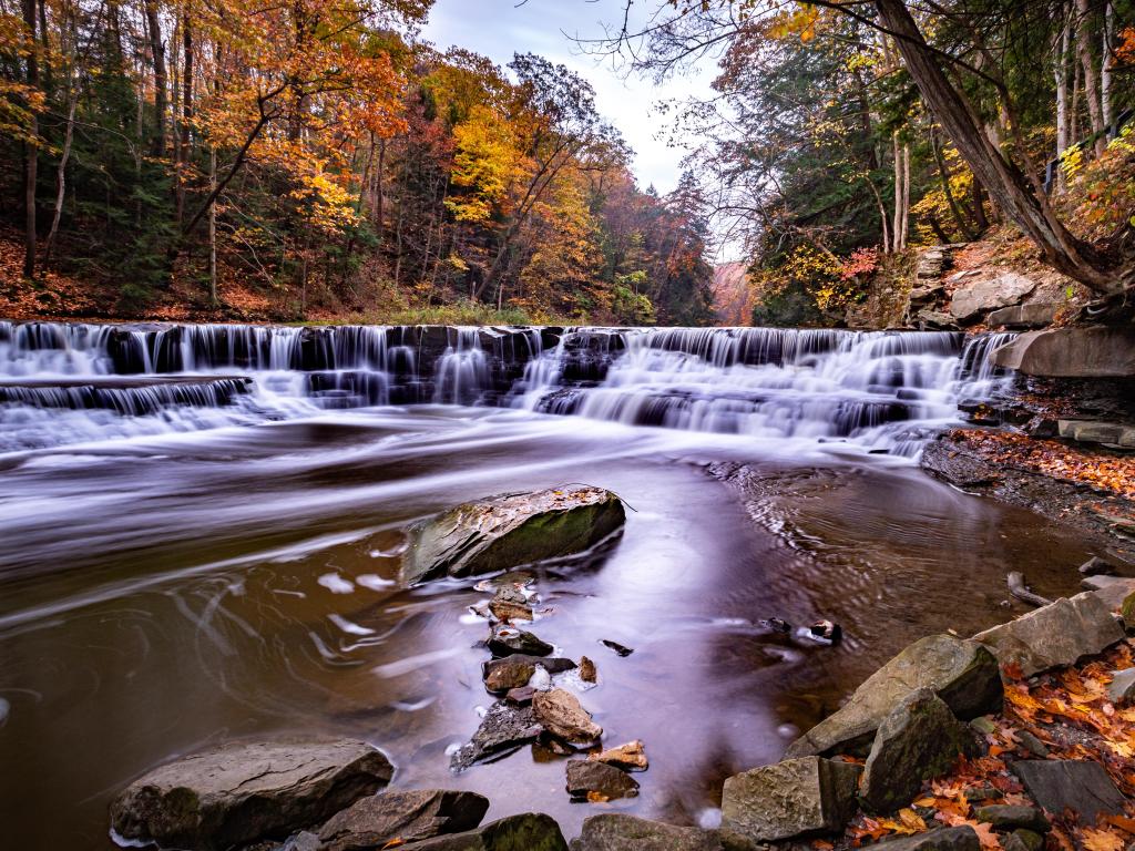 Cuyahoga Valley National Park, USA with a charging river taken during fall, waterfalls in the background and golden trees.