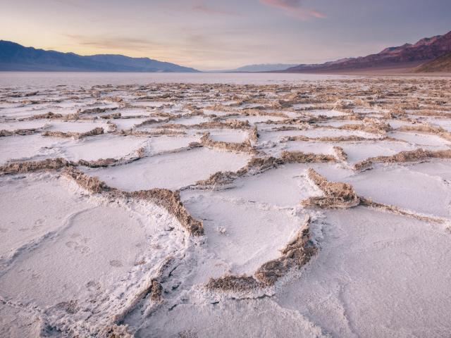 Badwater Basin salt flats in Death Valley National Park during a misty sunset