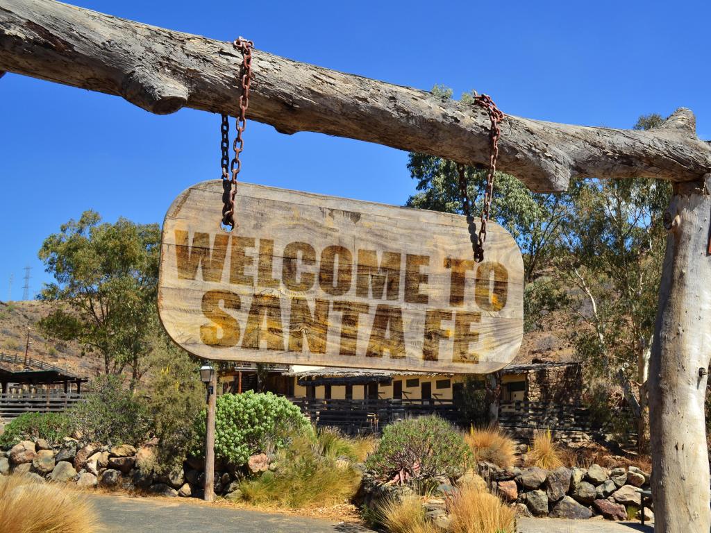 Santa Fe, New Mexico, USA with an old vintage wood signboard with text 