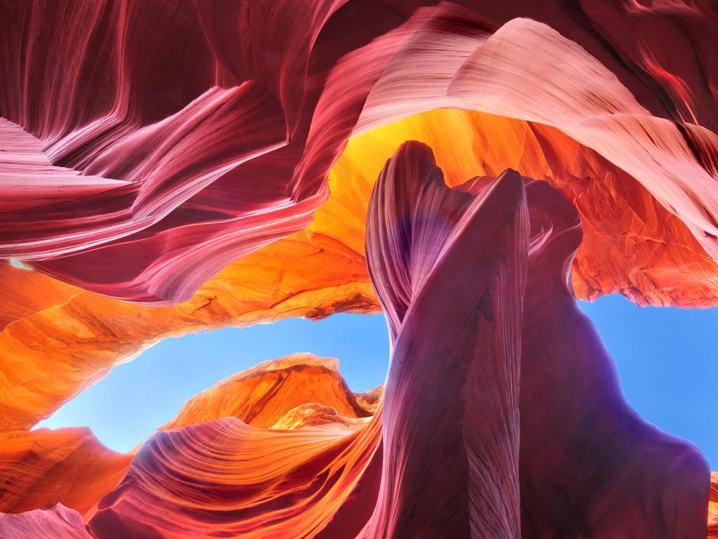 Antelope Canyon, near Page, Arizona, USA taken at the Navajo Reservation with stunning rock formations and beautiful colours, blue sky through the formations. 