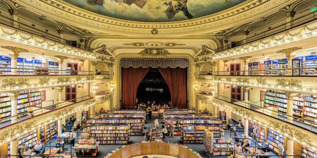 The inside of the El Ateneo Grand Splendid, Buenos Aires, Argentina, with a grand ceiling fresco, ornate gold surroundings and rows of books visible
