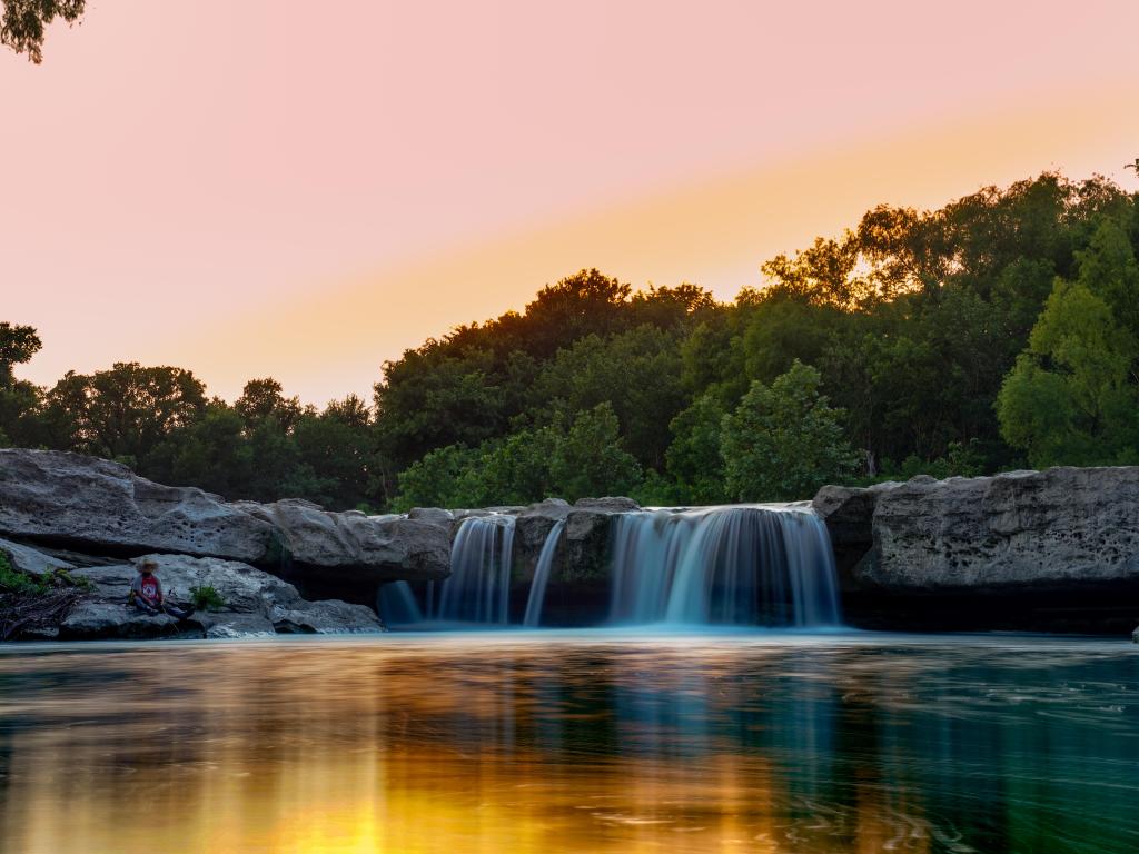 Onion creek running through mckinney falls at sunset, with its fast paced running waterfalls 