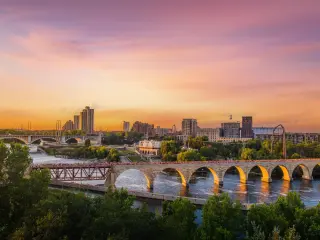 Sunset on the Mississippi River with the famous bridge and city's skyline in the background