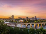 Sunset on the Mississippi River with the famous bridge and city's skyline in the background
