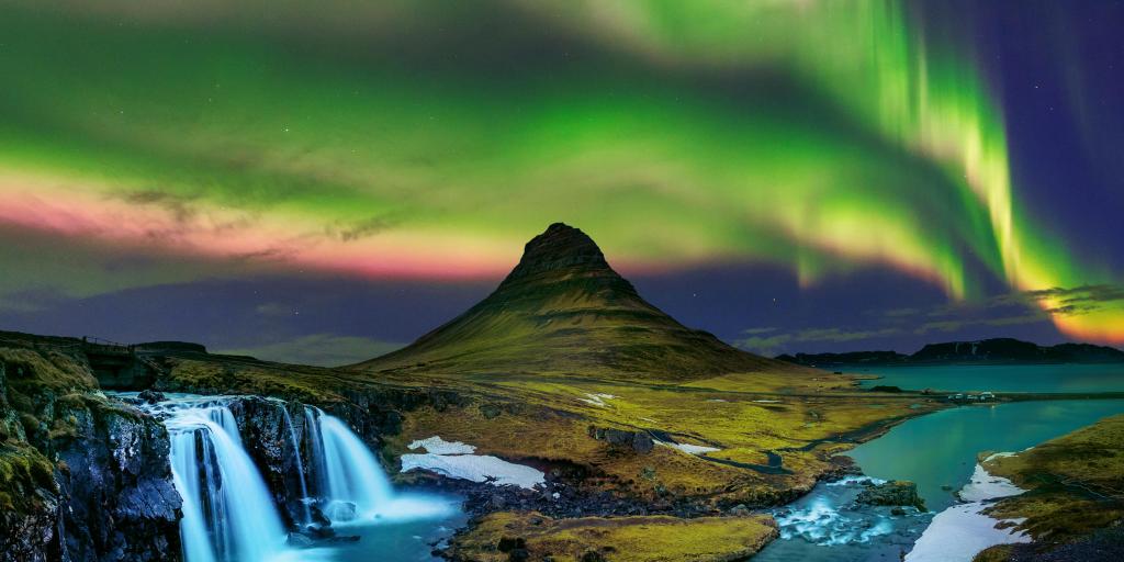 Northern lights in the Iceland sky above a waterfall