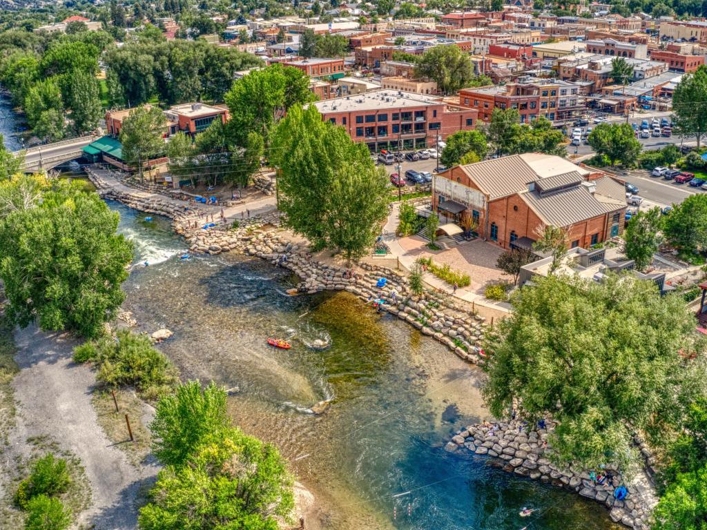 Aerial view of Salida, Colorado, with its red brick buildings set back from the banks of the Arkansas River