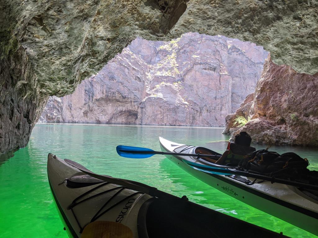 Two kayaks in a cave with beautiful turquoise waters