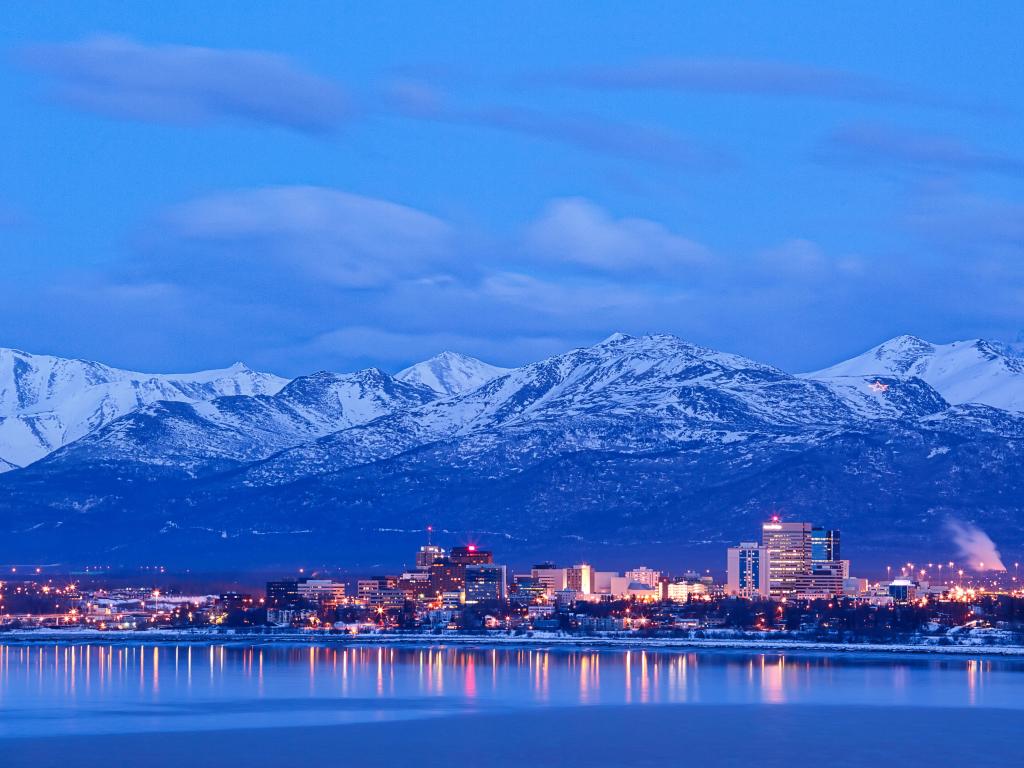 Anchorage Alaska skyline in winter at dusk with the Chugach mountains behind