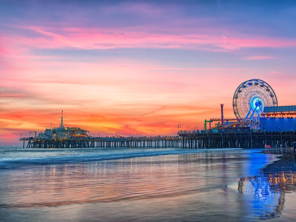 Santa Monica, Los Angeles, California, USA with the Santa Monica Pier in the distance taken at sunset.