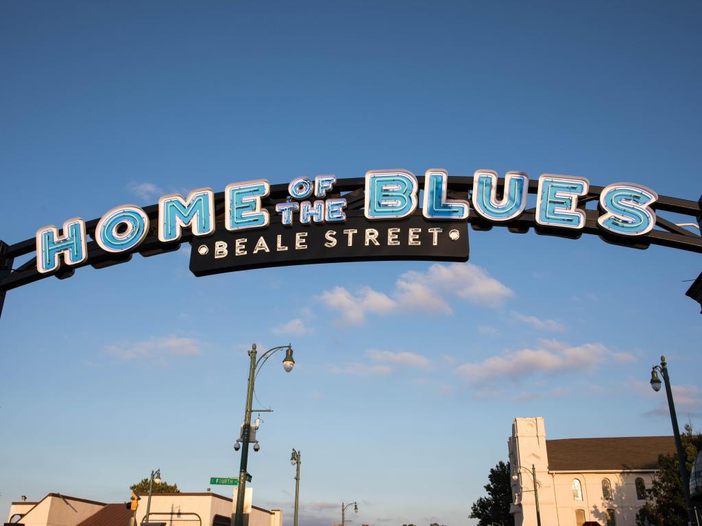 "Home of the Blues" sign at the entrance of Beale Street on a sunny day