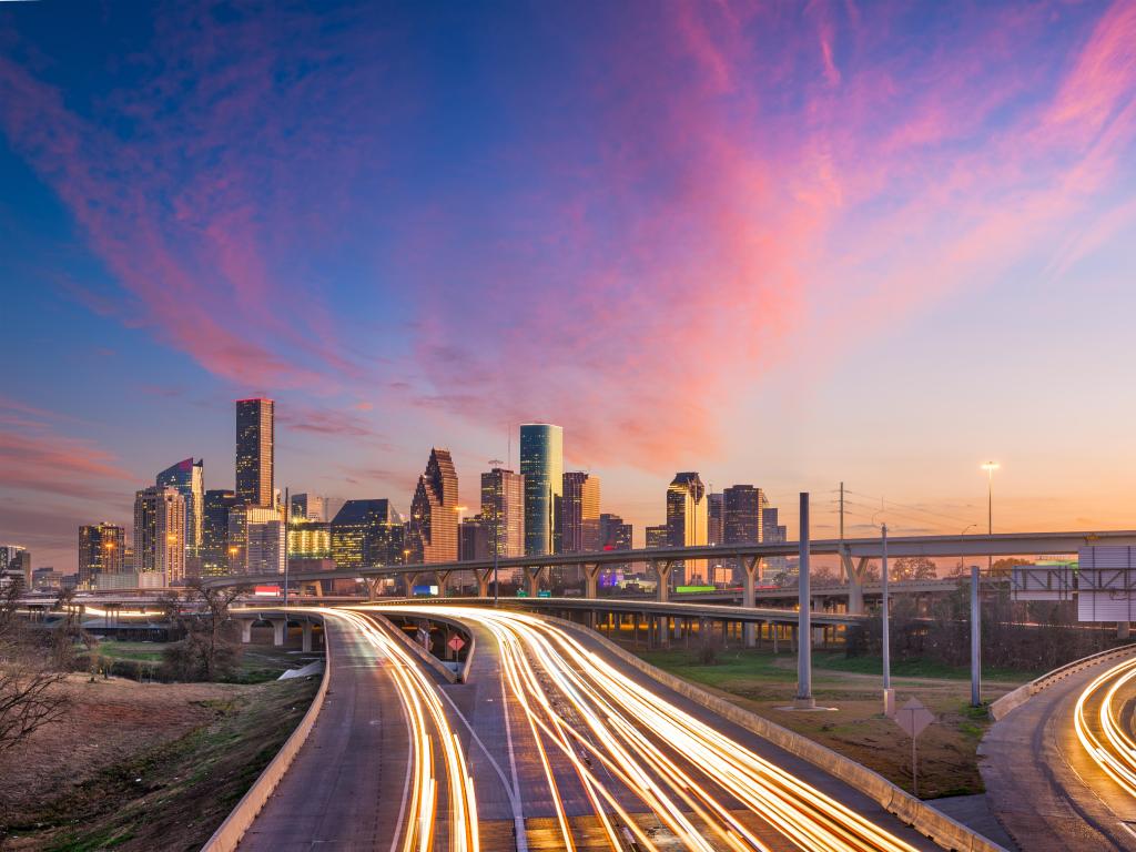 Houston, Texas, USA with the downtown skyline over the highways at dusk.