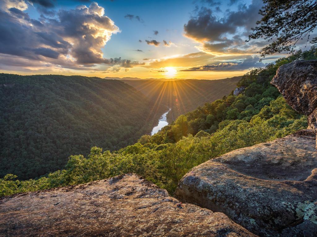 The sun beaming through the green mountain peaks in West Virginia