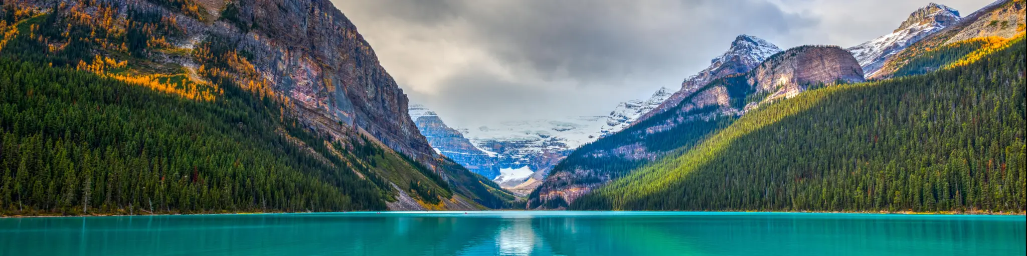 Banff National Park, Rocky Mountains, Alberta, Canada with beautiful autumn views of iconic Lake Louise, with the mountains and forest in the background.