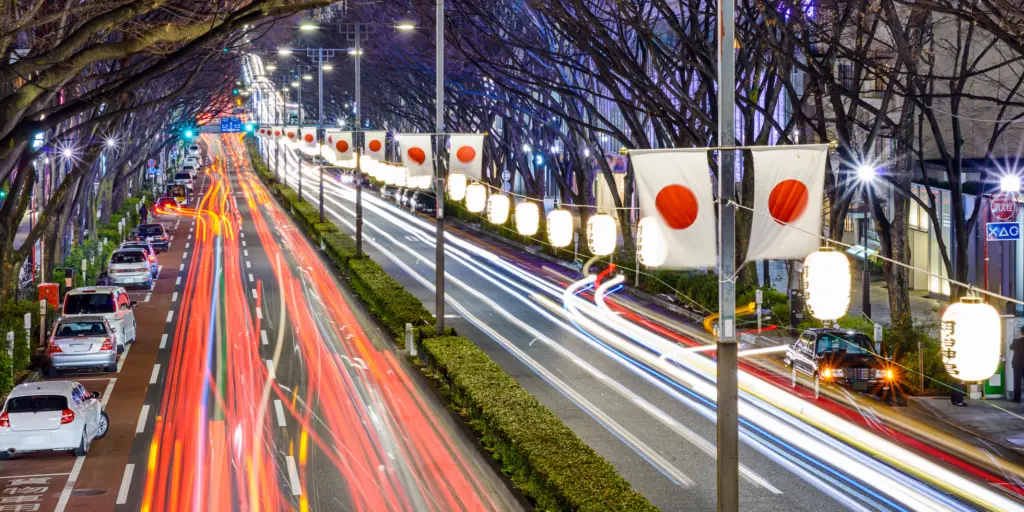 Blurred headlights of cars driving at night in Japan
