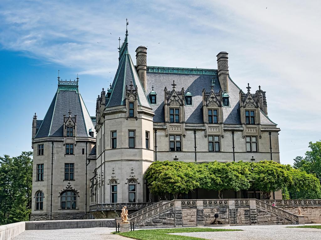 Biltmore Estate in Ashville, North Carolina, is a majestic estate. The photo is taken from the front of the building on a mostly clear day.