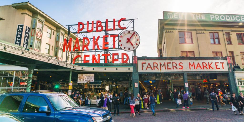 People visit the popular Pike Place Market in Seattle on a sunny day