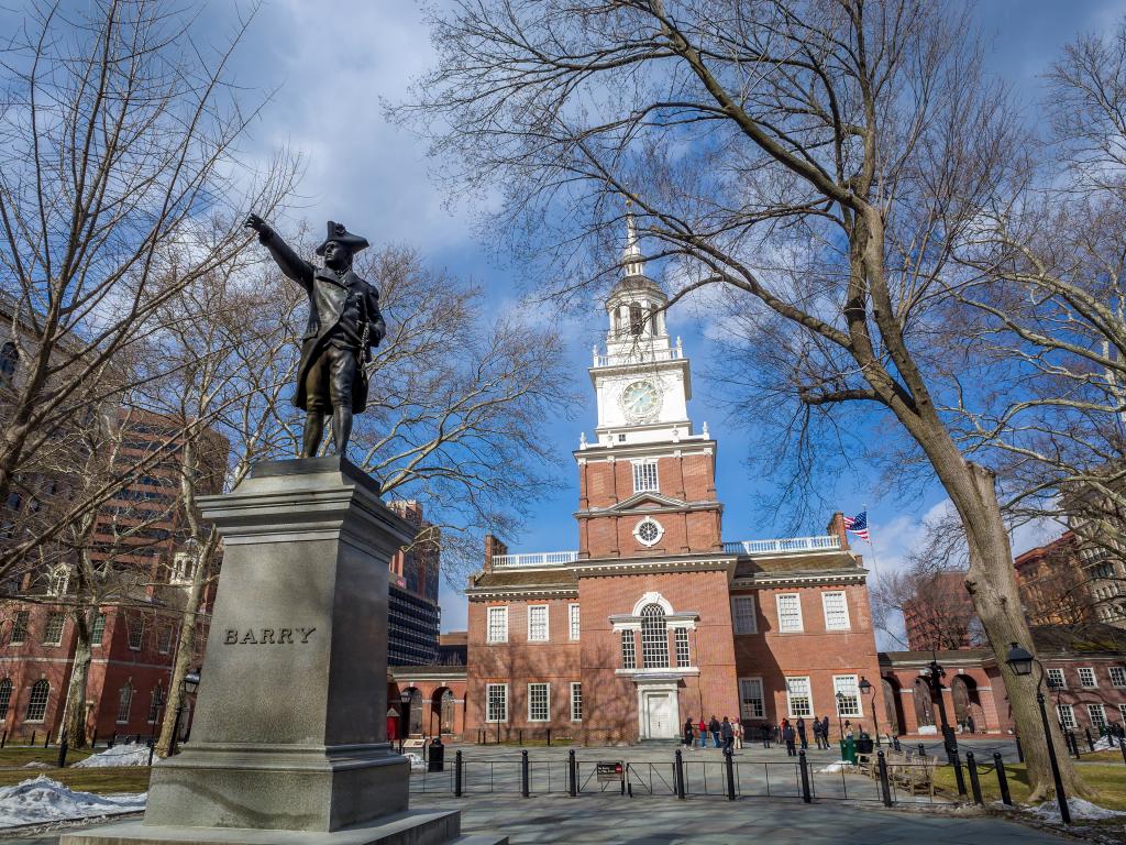 The Independence Hall at the Independence National Historical Park during a bright day with some visitors.