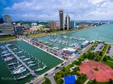 Skyline view of Corpus Christi Texas, overlooking harbor bridge and rows of piers filled with boats and sailboats 