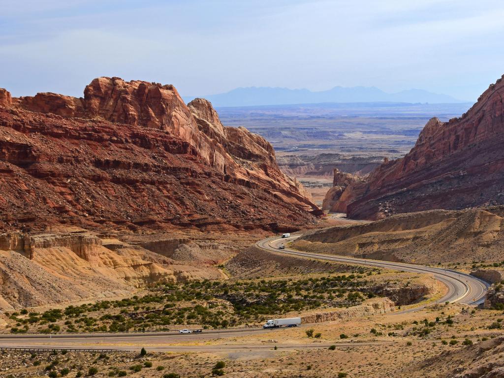 Trucks traveling through a pass in the incredible rock formations of San Rafael Swell in a very remote part of Utah, near Green River